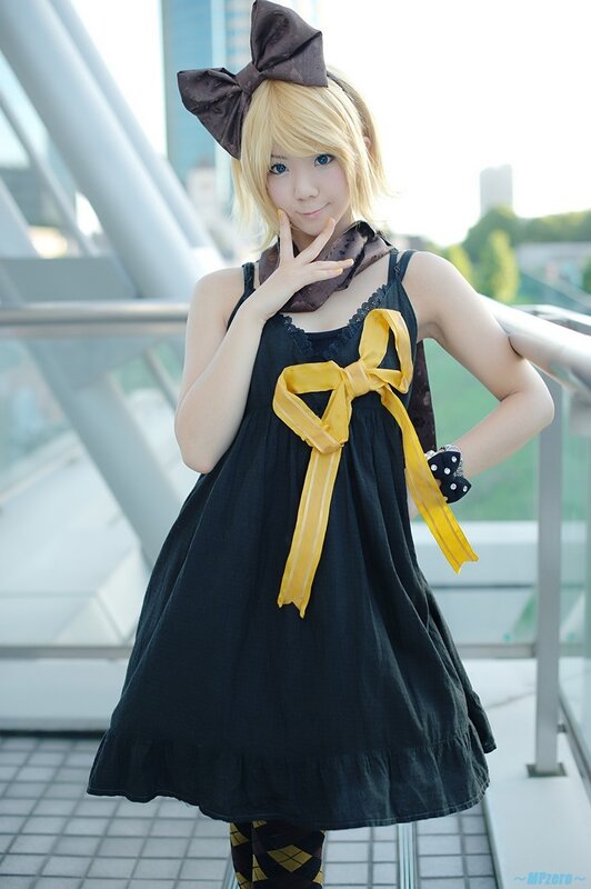 cosplayer in black dress with yellow bow