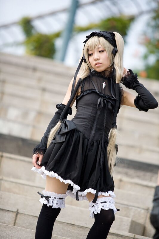 cosplayer in black maid outfit
