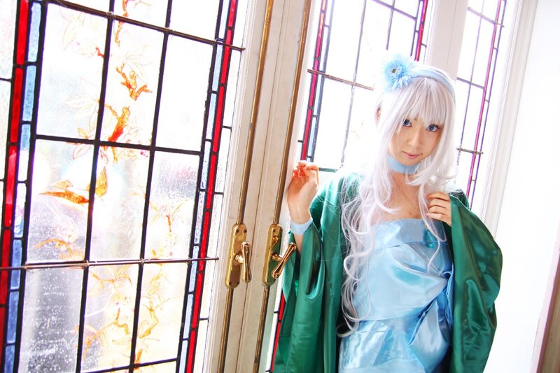 cosplayer in blue dress by stained glass