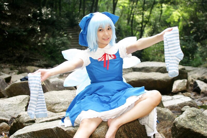 Cosplayer in blue dress on rocks