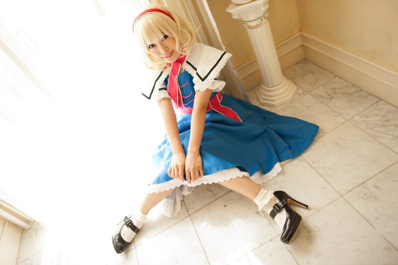 cosplayer in blue dress sitting