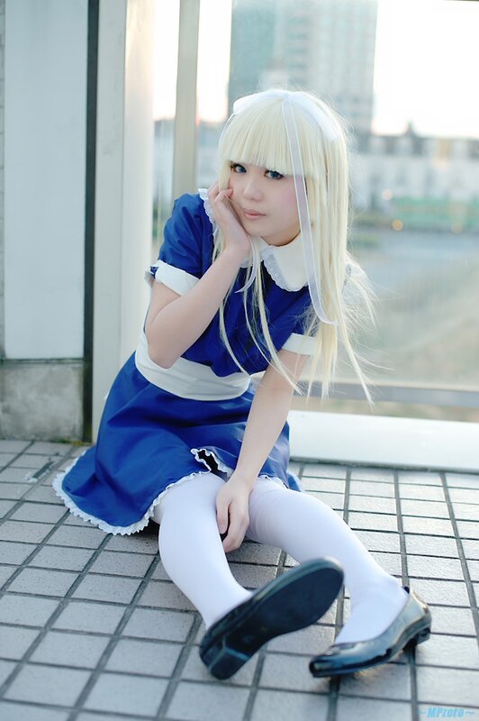 cosplayer in blue dress sitting