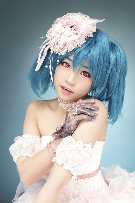 cosplayer in blue wig and lace dress
