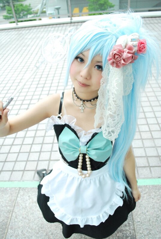 cosplayer in blue wig and maid outfit