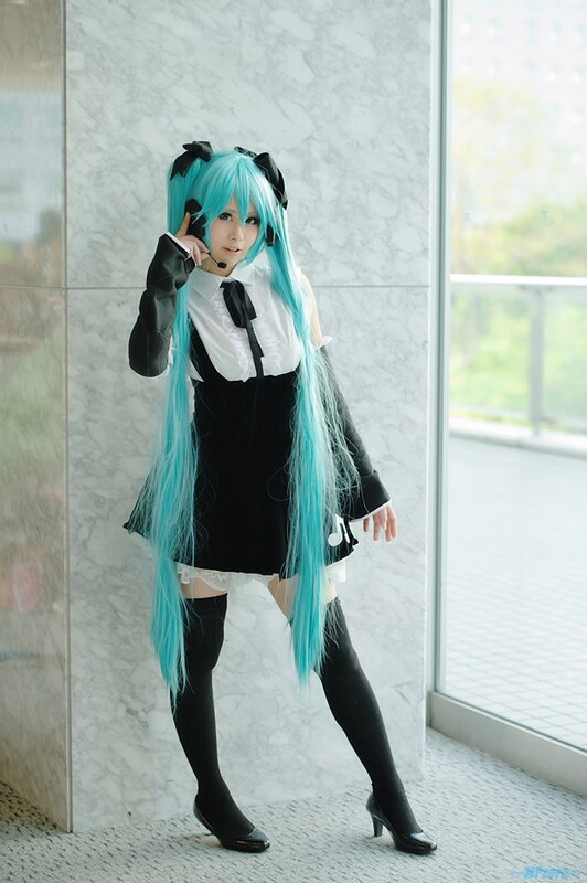 cosplayer in blue wig and maid outfit