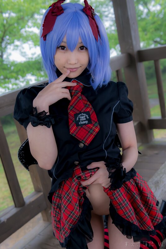 cosplayer in blue wig and plaid outfit