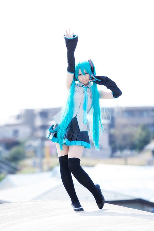cosplayer in blue wig and school uniform