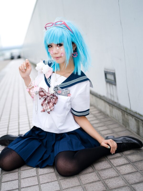 cosplayer in blue wig and school uniform