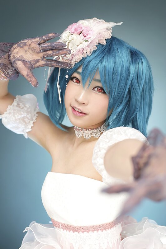 cosplayer in blue wig and white dress