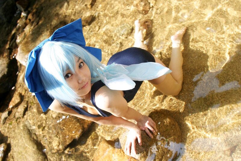 cosplayer in blue wig at water's edge