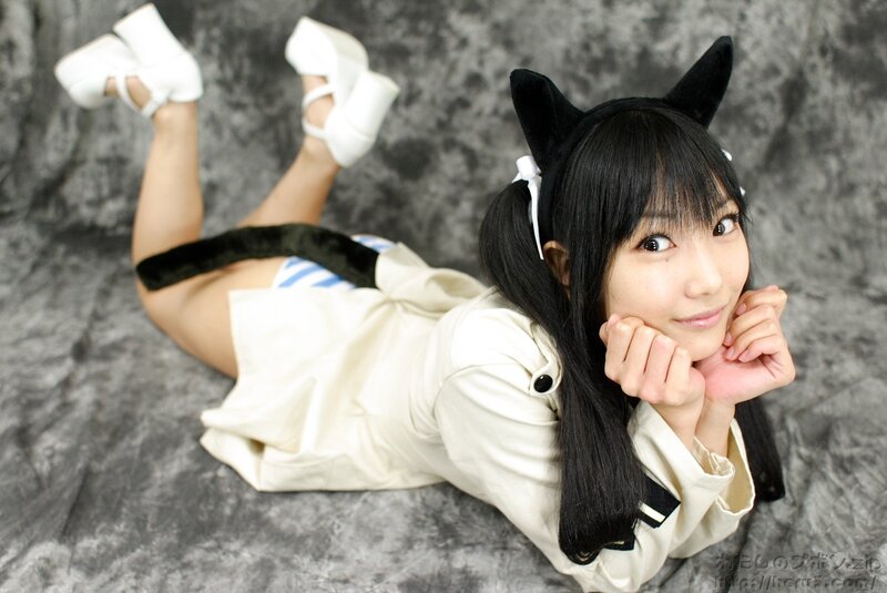 cosplayer in cat ears and white outfit