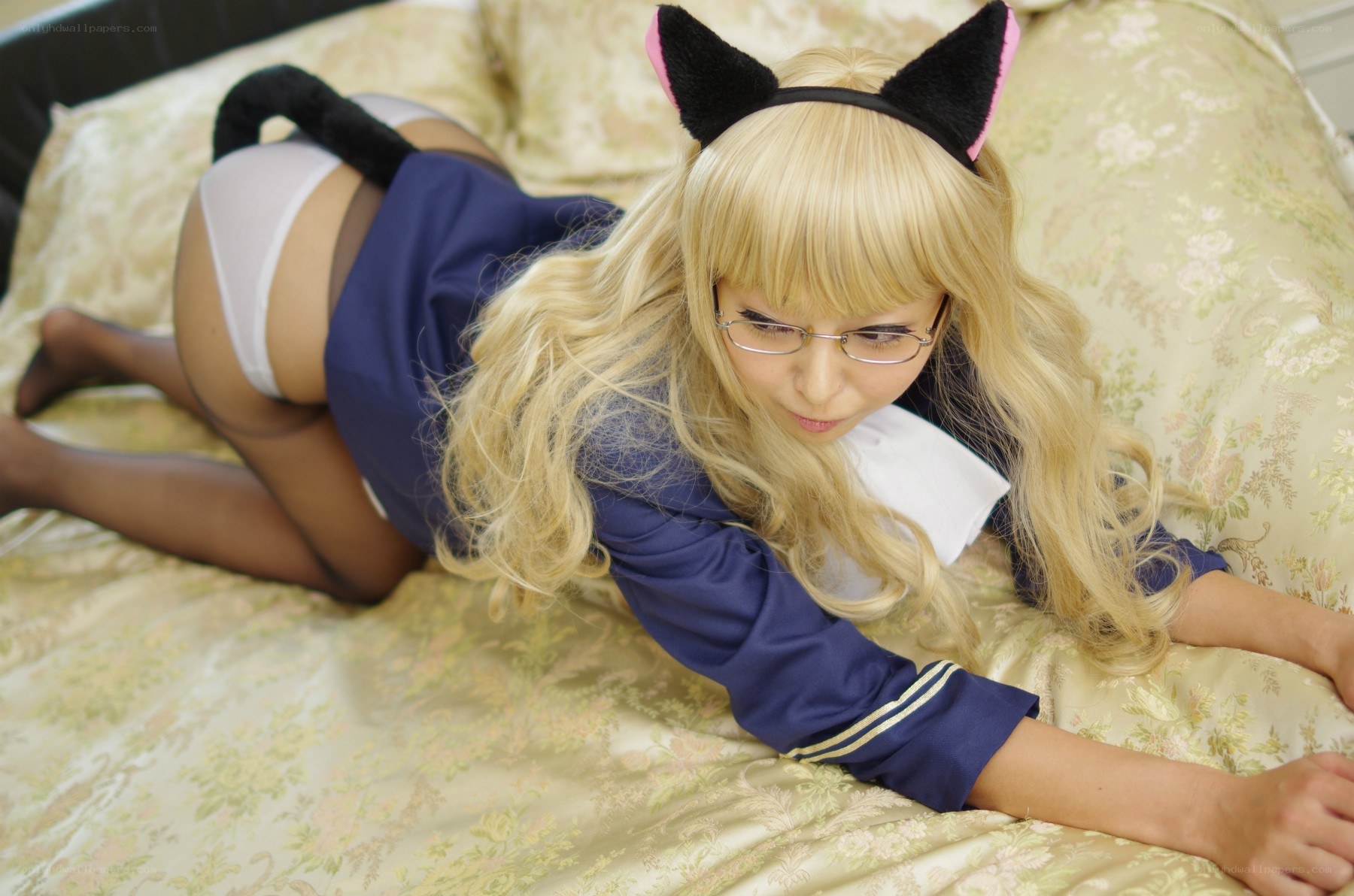 cosplayer in cat ears on bed