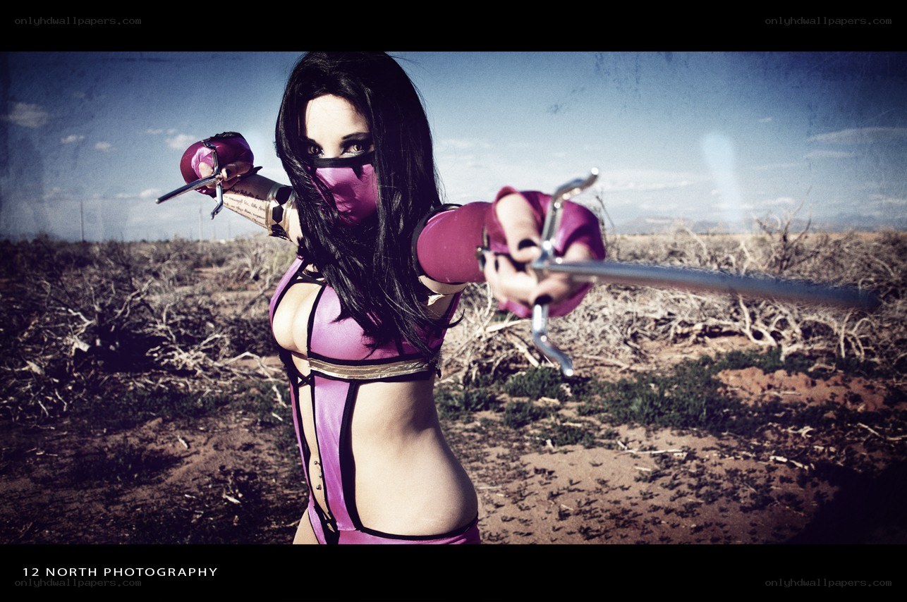 cosplayer in desert with swords