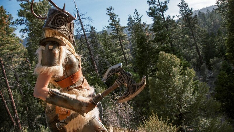 cosplayer in forest with axe