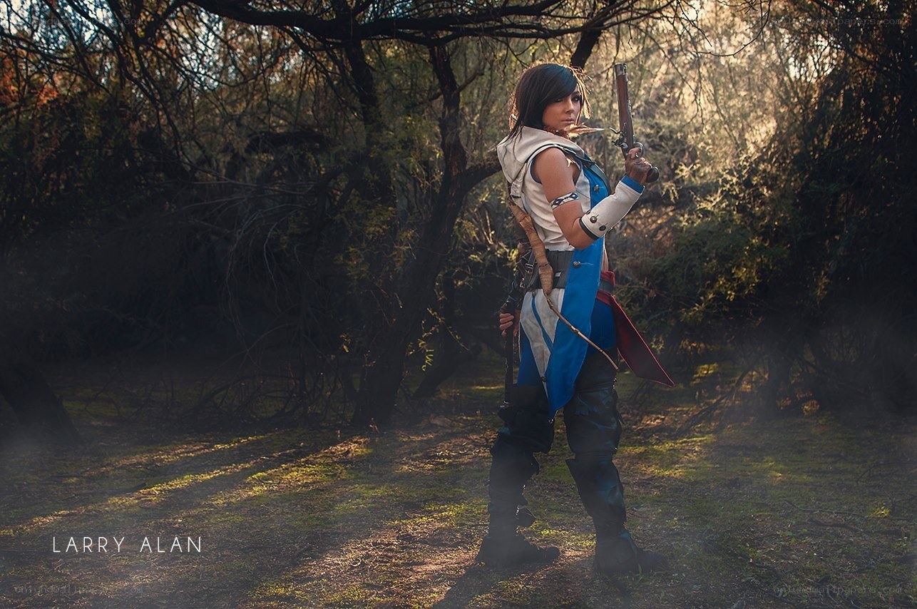 cosplayer in forest with gun