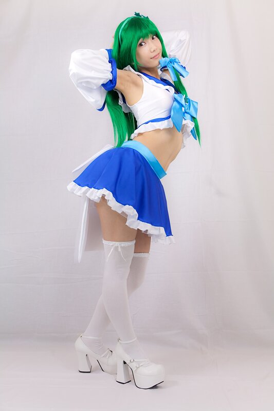 cosplayer in green wig and blue outfit