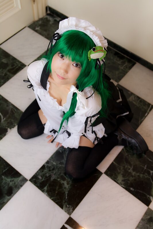 cosplayer in green wig and maid outfit