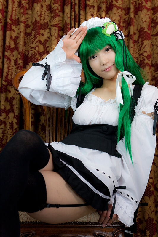 cosplayer in green wig and maid outfit