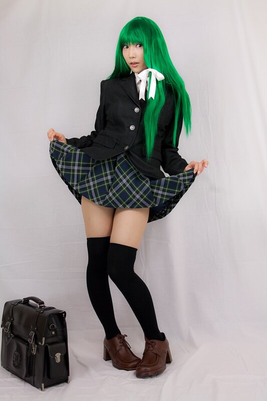cosplayer in green wig and school uniform