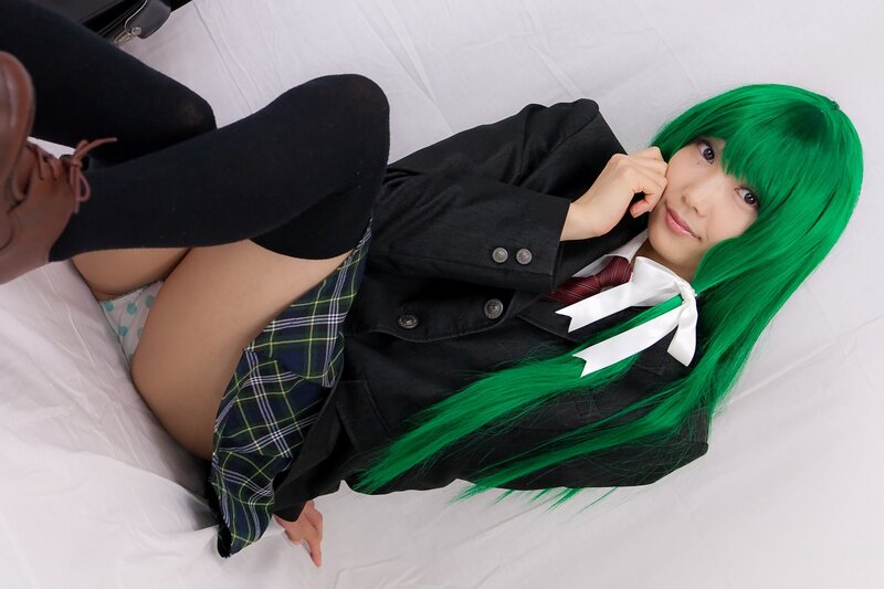 cosplayer in green wig and school uniform