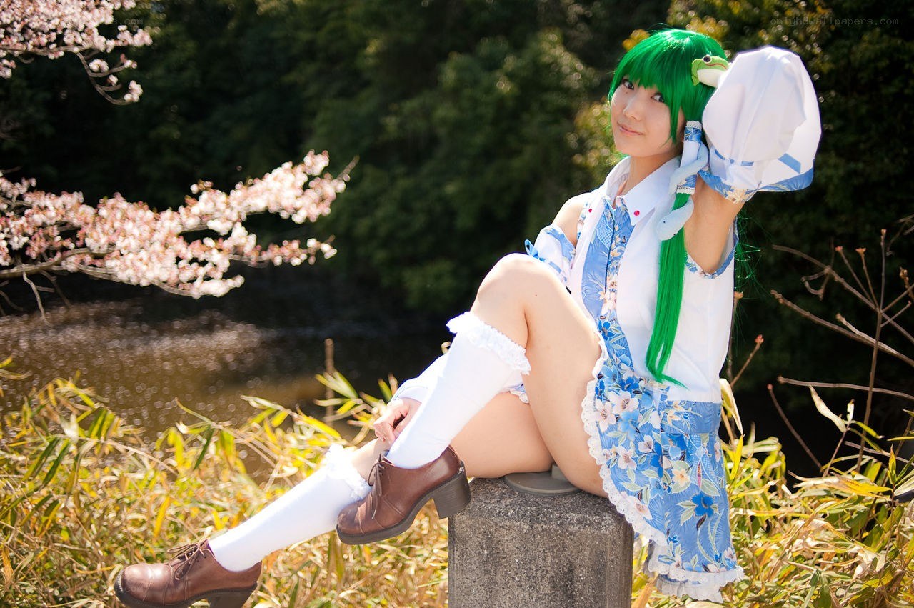 cosplayer in green wig by river