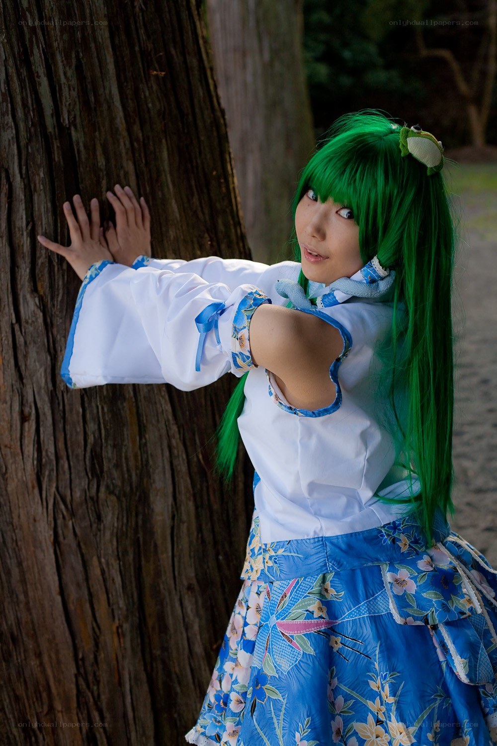 cosplayer in green wig by tree