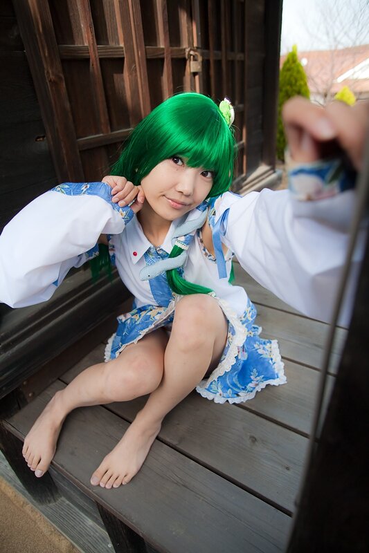 cosplayer in green wig on porch