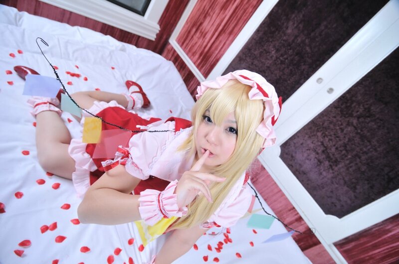 cosplayer in maid outfit on bed