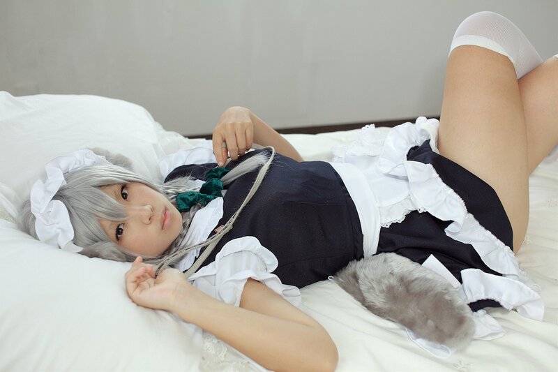 cosplayer in maid outfit on bed