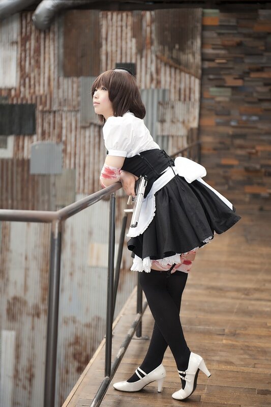 cosplayer in maid outfit with gun