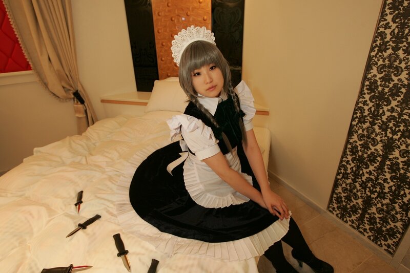 cosplayer in maid outfit with knives