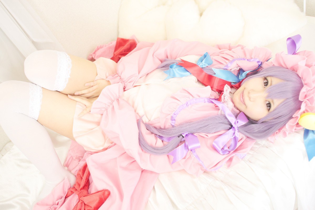 cosplayer in pink dress lying down