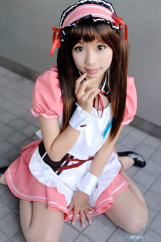 cosplayer in pink maid outfit