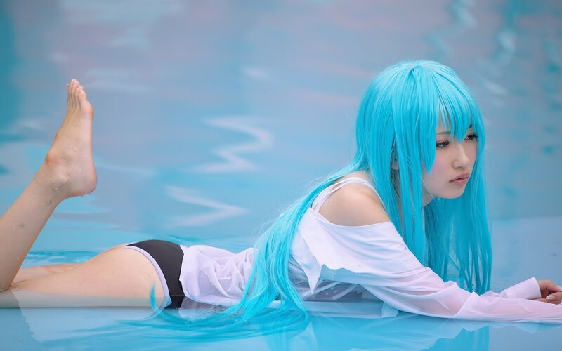 cosplayer in pool with blue wig