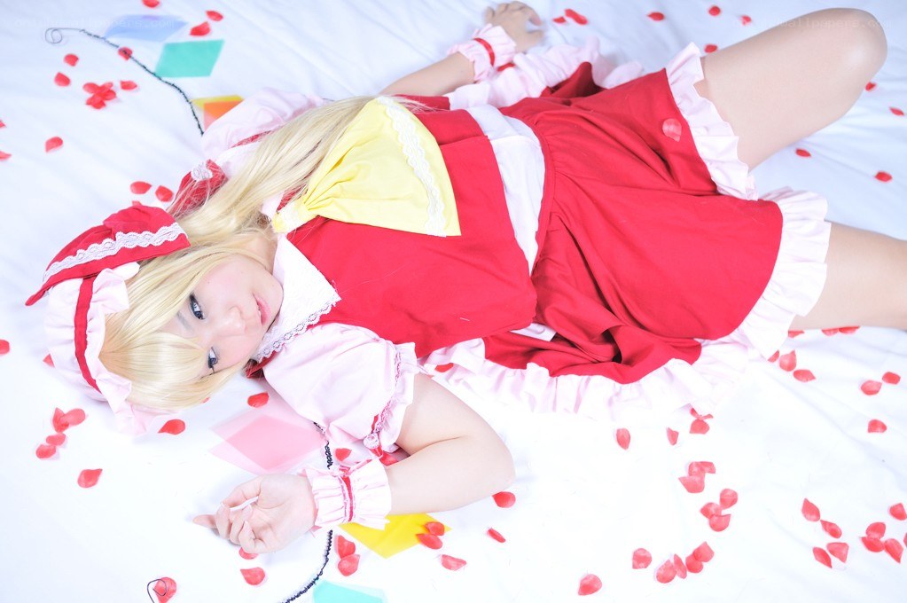 cosplayer in red dress lying on bed