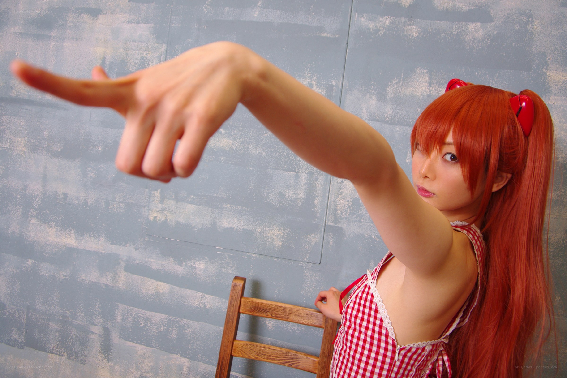 cosplayer in red dress pointing