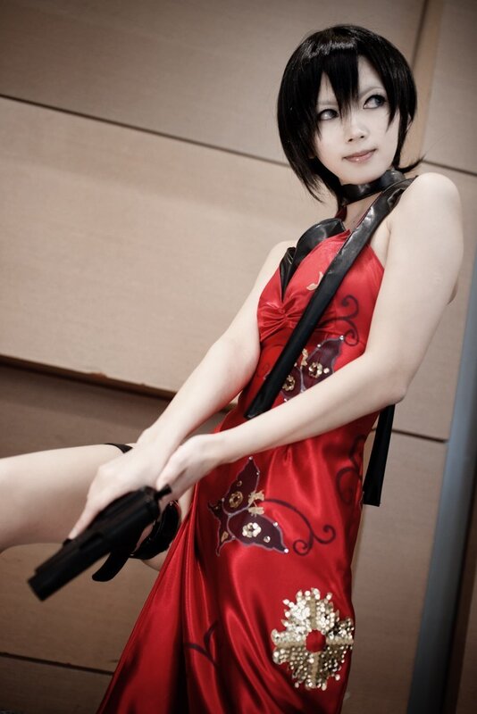 cosplayer in red dress with gun