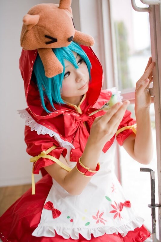 cosplayer in red dress with plush toy