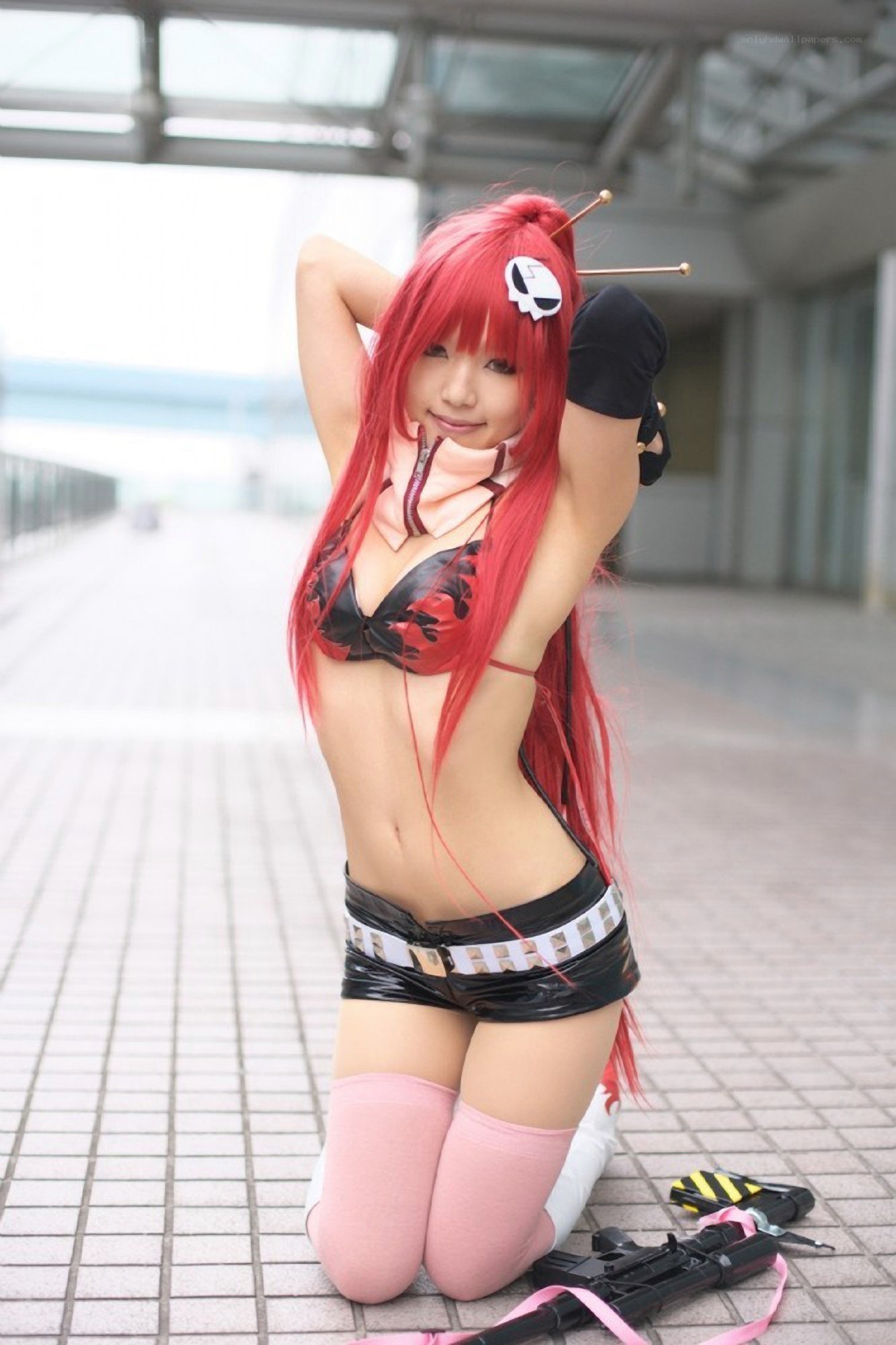cosplayer in red wig kneeling