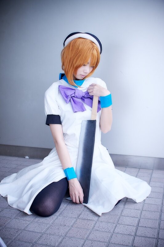 cosplayer in white dress holding sword