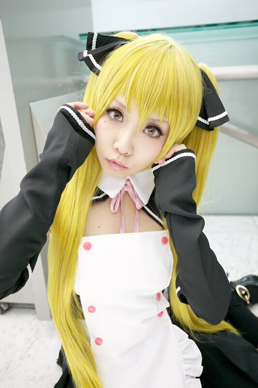 cosplayer in yellow wig and maid outfit