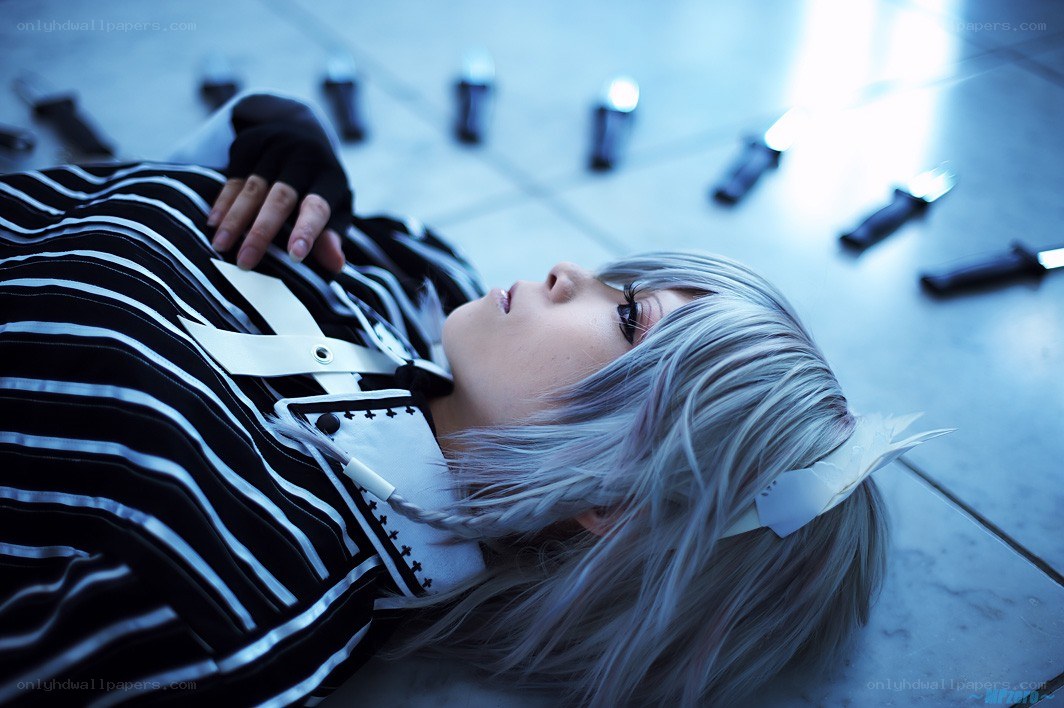 cosplayer lying on floor with knives