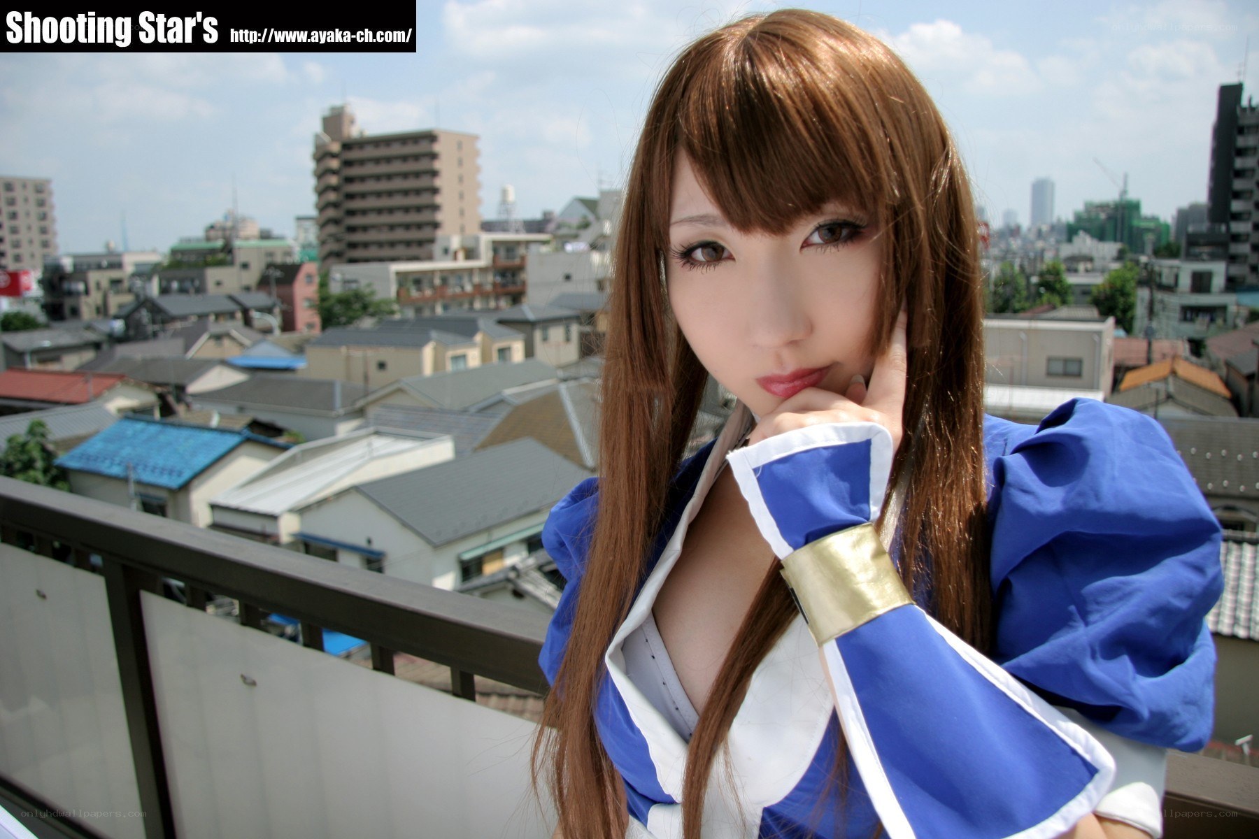 cosplayer on balcony overlooking city
