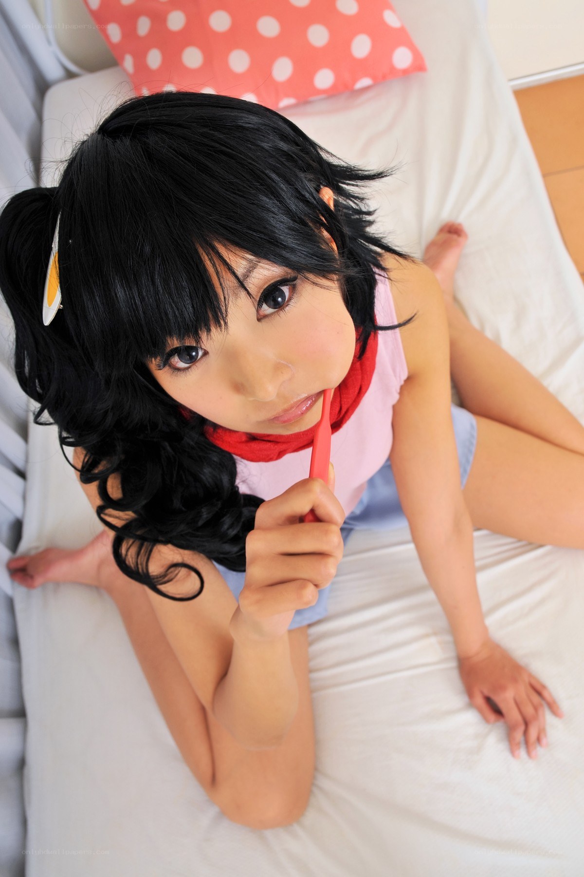 cosplayer on bed with toothbrush