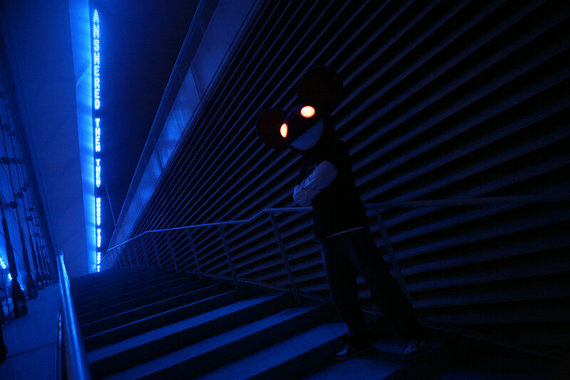 cosplayer on blue-lit stairs