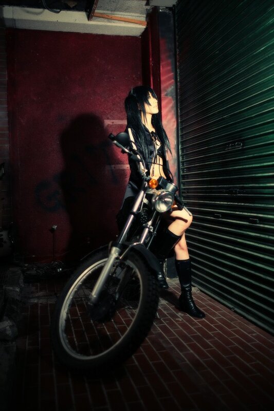 cosplayer on motorcycle in alley