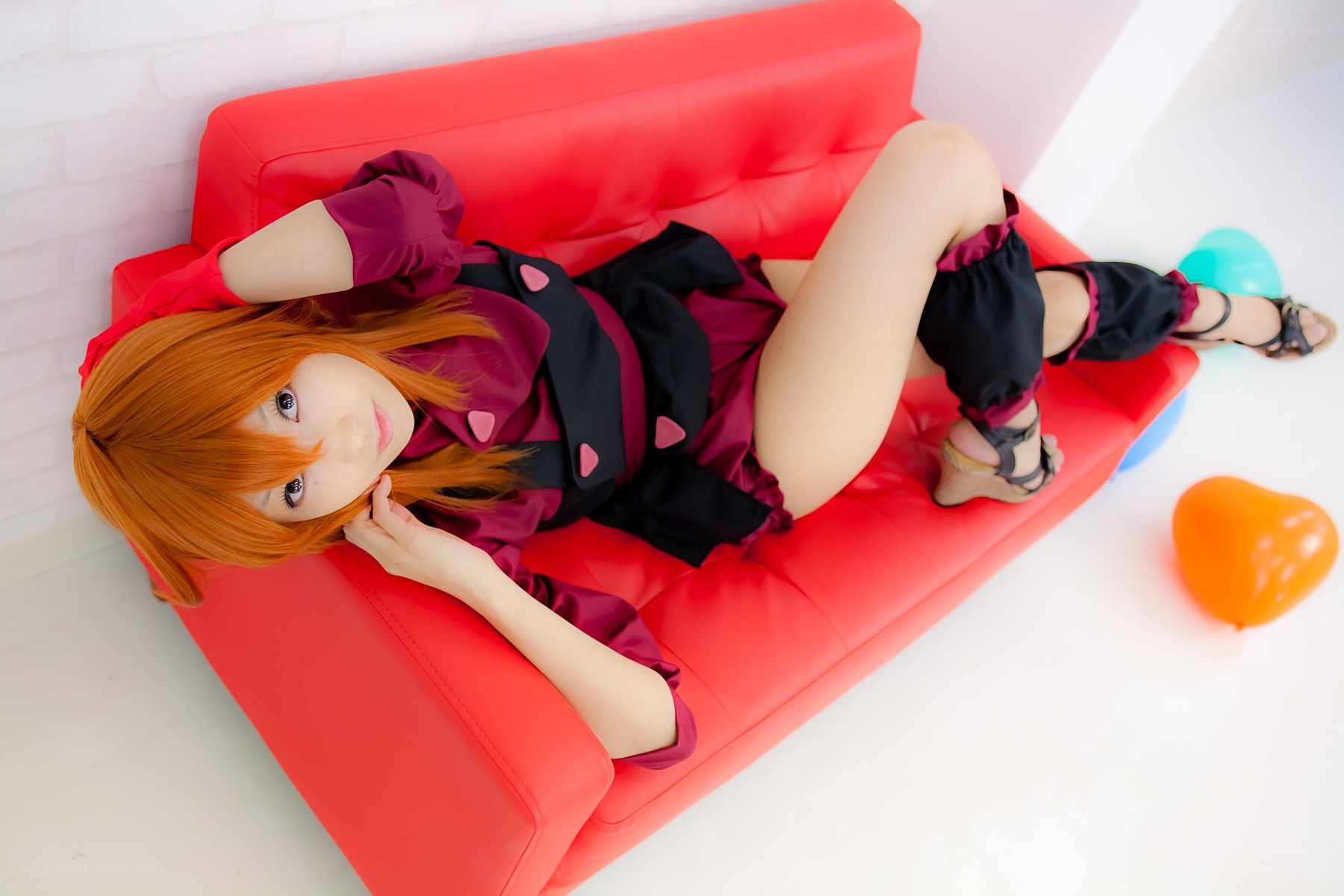 cosplayer on red couch