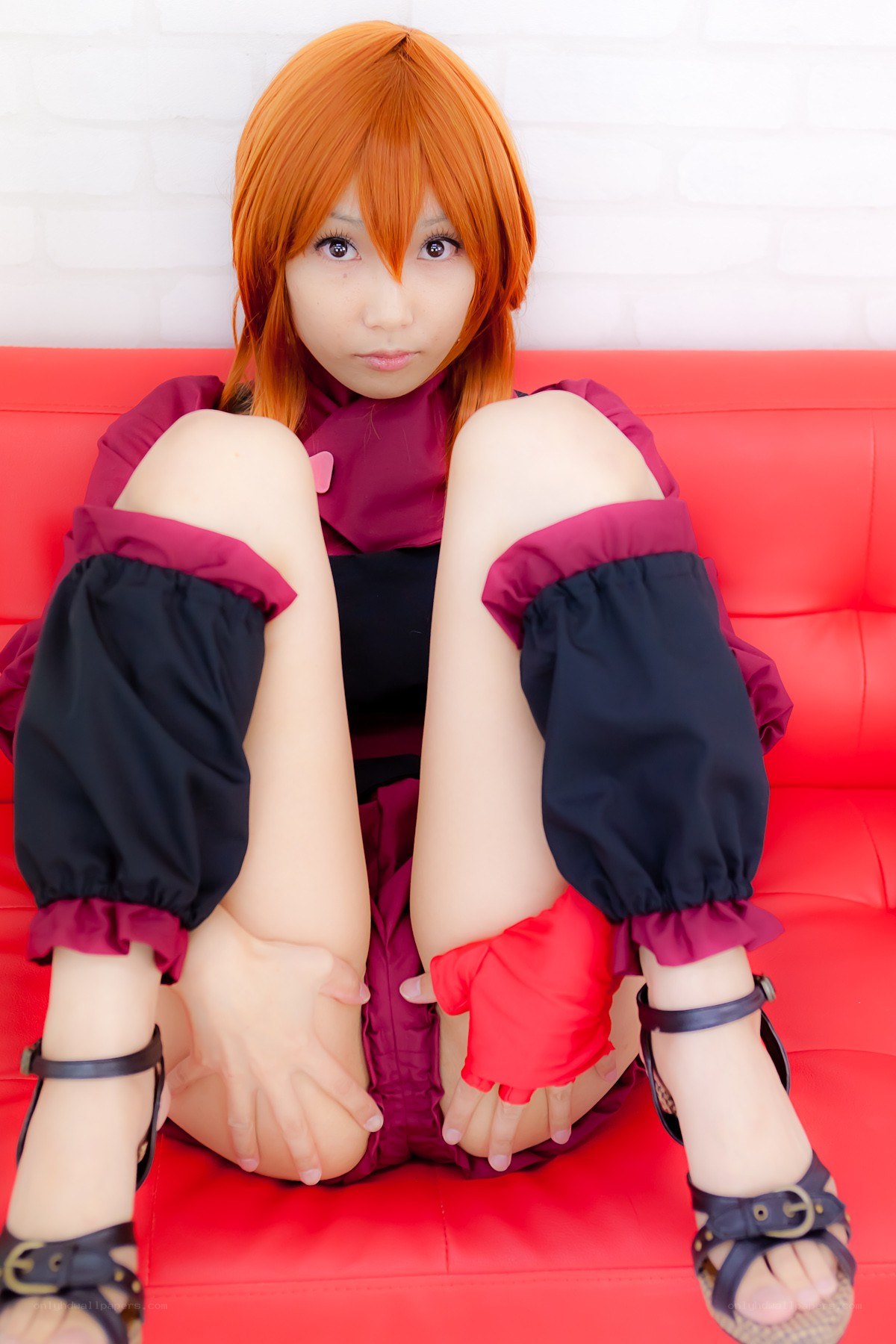 cosplayer on red couch