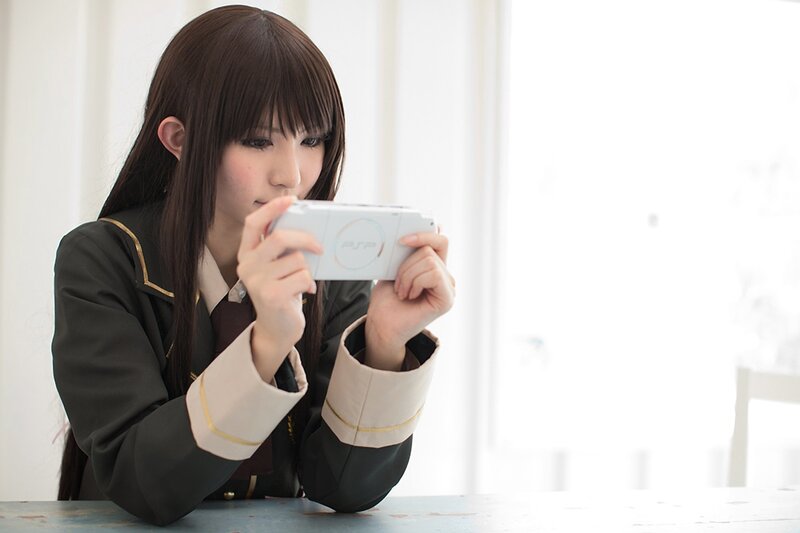 cosplayer playing psp