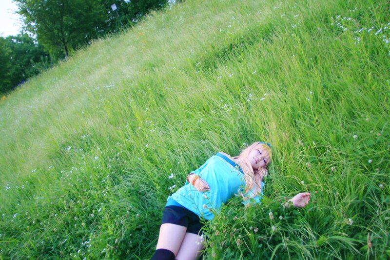 Cosplayer resting in a field